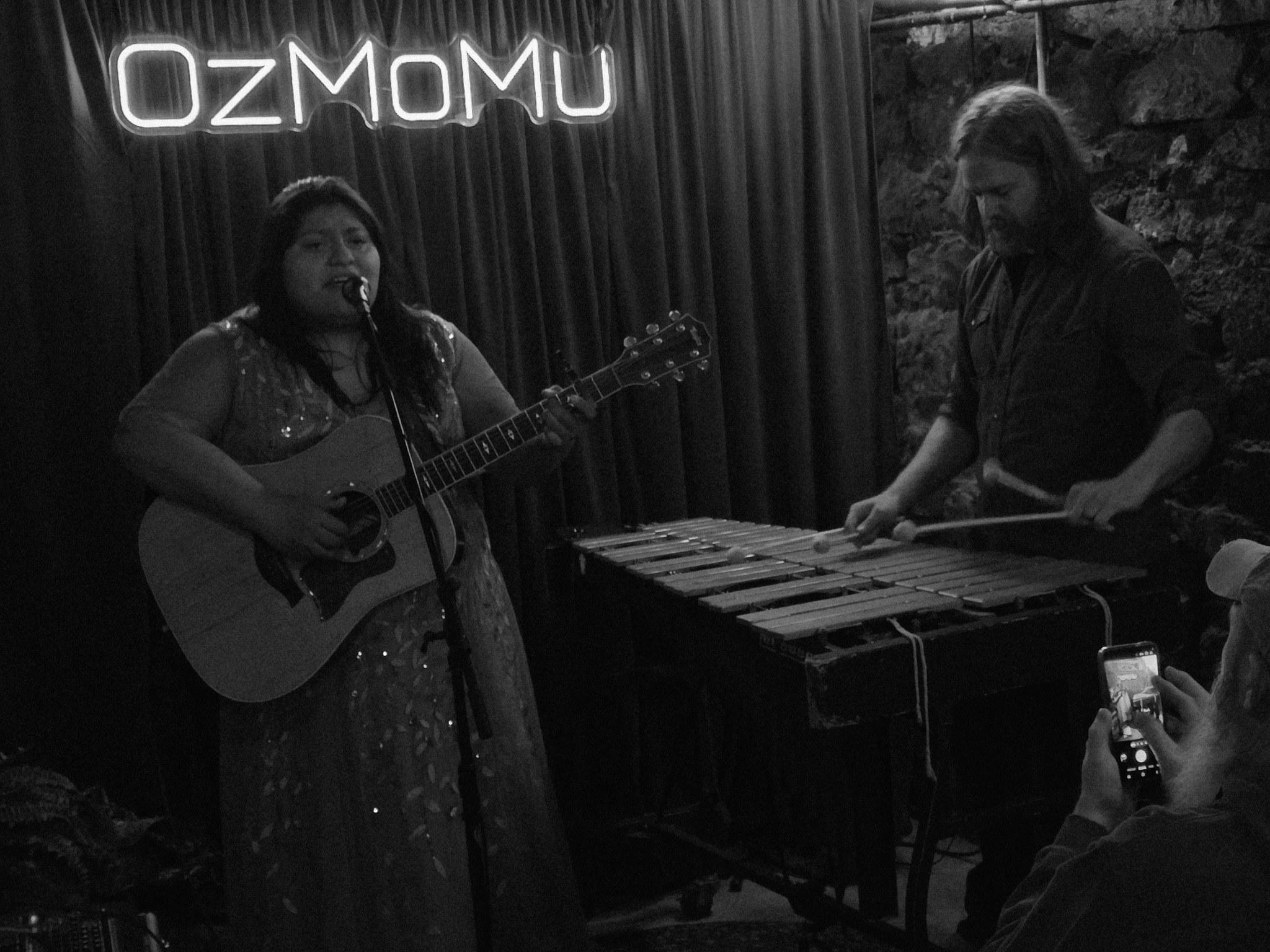 Carolina Mendoza with Adam Collins, OzMoMu’s Artist at Large, performing in The Cave at the Basin Park Hotel in Eureka Springs, Arkansas · OzMoMu 2026.