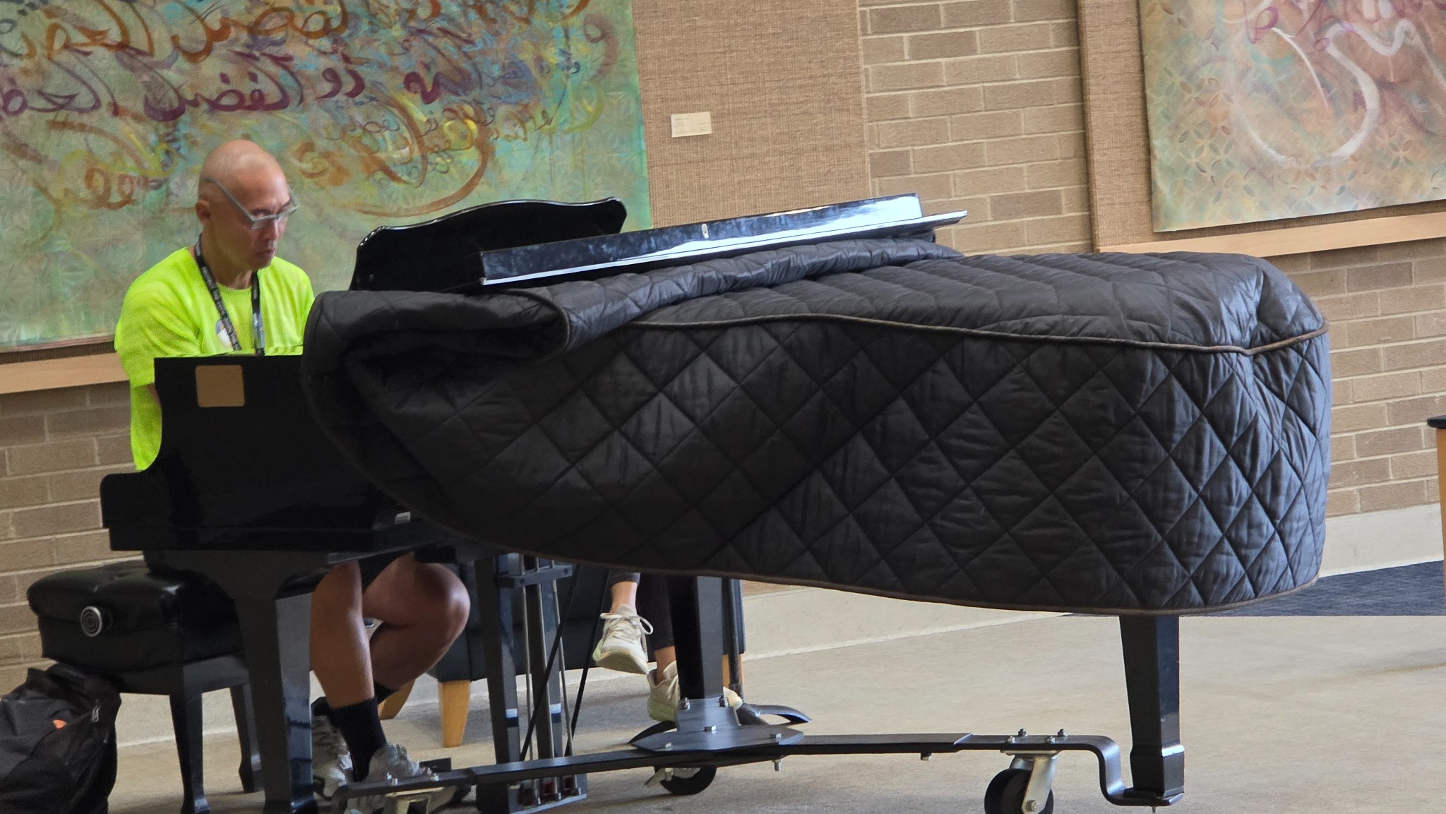 A pianist playing in the hospital lobby.